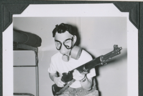Paul Ohashi in gas mask holding gun (ddr-densho-442-138)