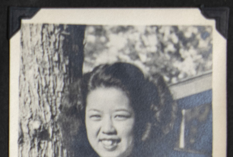Smiling woman wearing a locket (ddr-densho-542-748)