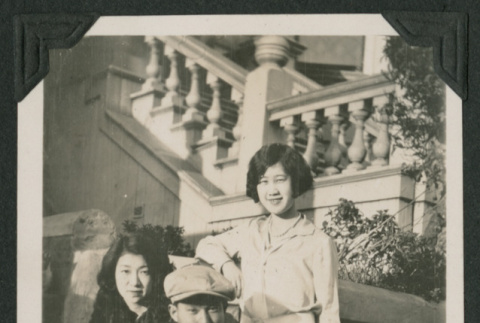 man and two women sitting on steps (ddr-densho-378-554)