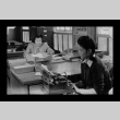 T. Heya and S. Nishihara in the Amache Co-op office (ddr-csujad-55-1547)