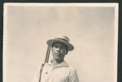 Photo of a man with a shotgun (ddr-densho-483-219)
