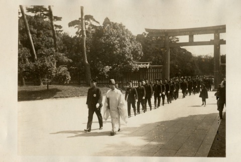 A Shinto priest leading men in uniform through the gates of a shrine (ddr-njpa-8-49)