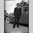 Man in a suit in front of car (ddr-densho-475-80)