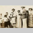 Men, women, and children at a gathering (ddr-njpa-1-804)