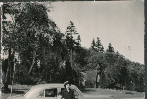 Chester Sakura Jr with woman standing by car (ddr-densho-523-209)