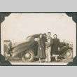 Three adults and girl standing next to car (ddr-densho-316-354)