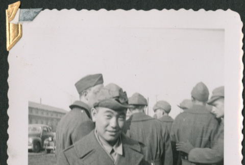 Man in uniform with group behind him (ddr-densho-434-74)