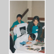 Staff and volunteers at t-shirt table (ddr-densho-506-129)