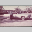 Man standing next to car (ddr-densho-523-604)