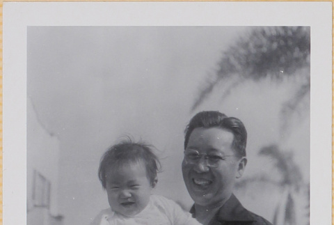 Man holding Leslie Shiomi (ddr-densho-522-400)