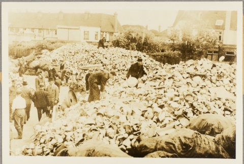 Men sorting through large piles of items (ddr-njpa-13-271)