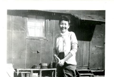 Woman standing in front of barracks (ddr-manz-6-76)