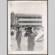 Man with camera standing by tents (ddr-densho-466-25)