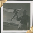 Man holding model glider (ddr-densho-434-140)