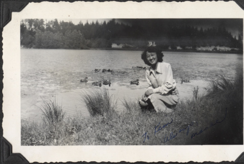 Woman by edge of pond with ducks (ddr-densho-466-930)