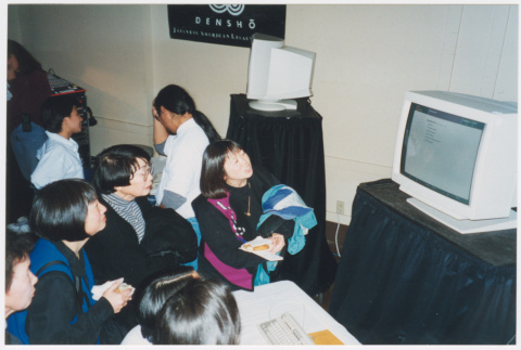 Gala attendees looking at computer displays (ddr-densho-506-120)