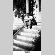 John Takakura sitting on steps (ddr-ajah-6-976)