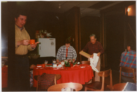 Tomoye and Henri Takahashi standing by table with gifts (ddr-densho-426-1295)