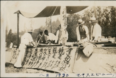 Men working at a table during a field day (ddr-densho-321-628)