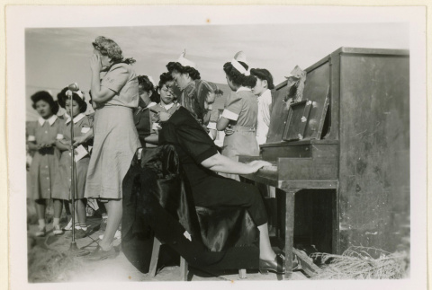 Pianist performs at a hospital tea party (ddr-densho-37-1249)