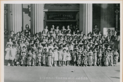 Large group photo of children standing in front of Buddhist Church Hongwanji (ddr-densho-426-2239)