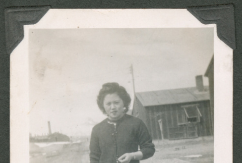 Woman standing outside barracks (ddr-densho-463-21)