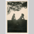 Two women sitting on ledge overlooking ocean (ddr-densho-368-217)