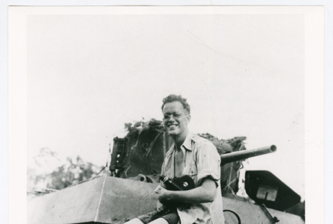 David Quaid sitting on a tank (ddr-densho-1007-332)
