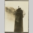 A man waving from the top of a smokestack (ddr-njpa-13-1448)