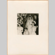 Henri Takahashi and Tomoye (Nozawa) Takahashi standing at altar with bridal party (ddr-densho-410-484)