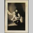 Tomoye (Nozawa) Takahashi posing with toy stuffed horse (ddr-densho-423-537)