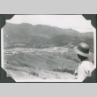 Man looking at camp on hillside from above (ddr-ajah-2-623)