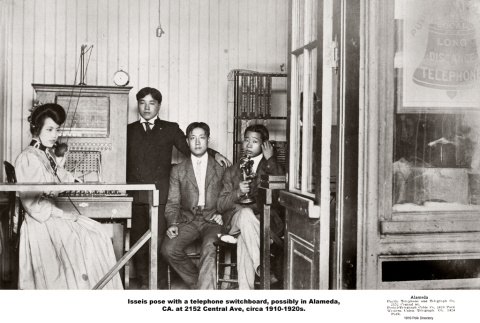 Three men and women posing with telephone switchboard (ddr-ajah-6-727)