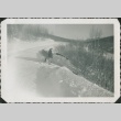Man looking at a car in a ditch (ddr-densho-321-335)