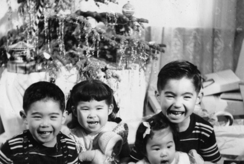 Four children by Christmas tree (ddr-ajah-6-952)