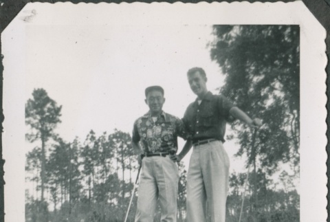 Two men stand with golf clubs (ddr-densho-321-389)