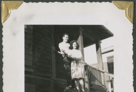 Man and woman standing on porch steps (ddr-densho-321-182)