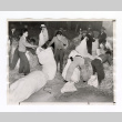 New arrivals at Manzanar fill mattresses with straw (ddr-csujad-52-27)