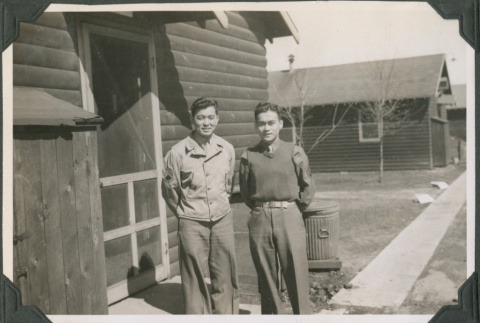 Two men outside camp building (ddr-ajah-2-538)