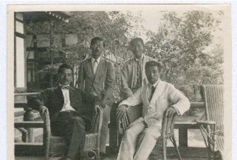 Group photograh of men on hotel porch (ddr-densho-335-265)