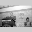 Stanley Diamond speaking, Wilma Chan at table (ddr-densho-1007-534)