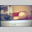 Display of enamelware pots, bowls (ddr-densho-426-319)