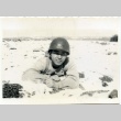 Soldier laying in a field (ddr-densho-22-366)