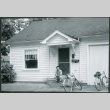 Man sitting on steps of house, with bicycles (ddr-densho-523-333)