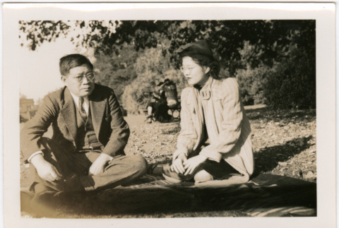 Tomoye (Nozawa) Takahashi and Tomoyuki Nozawa sitting in park (ddr-densho-426-2105)