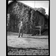 Young man in front of ivy-covered building (ddr-densho-475-127)