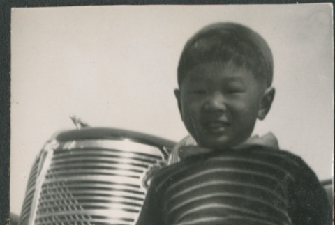 Boy standing in front of car (ddr-densho-523-112)