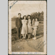Three women, a man and child standing in field (ddr-densho-316-377)