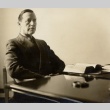 Man seated behind desk (ddr-njpa-2-360)