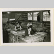 Group works on model ships (ddr-densho-37-1208)